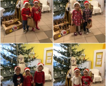 Zdjęcia przedstawiają dzieci z grupy „Biedronki” podczas wizyty ze Świętym Mikołajem - powiększ